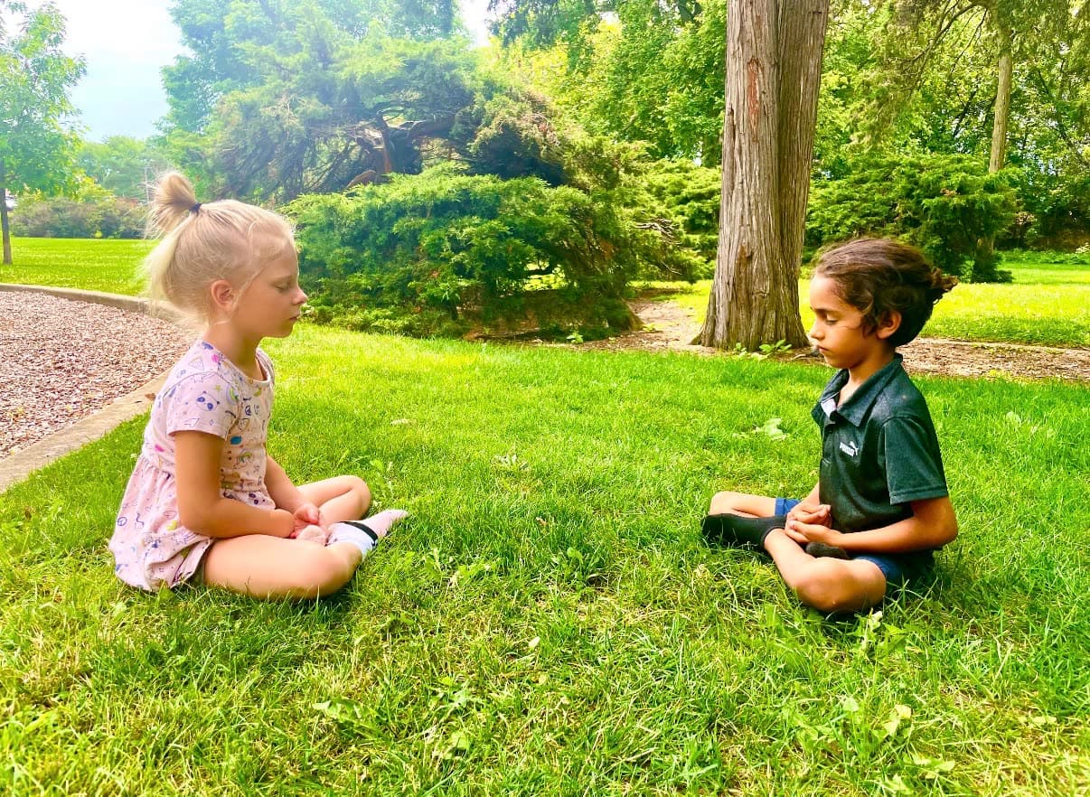 Children learning outdoors on the grass